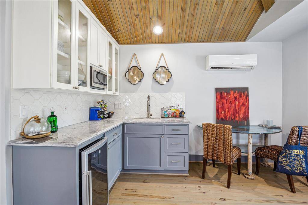 With a stunning vaulted wood-paneled ceiling and open layout, the garage apartment feels both spacious and cozy.