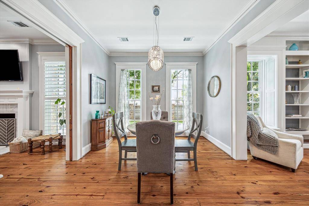 Light-filled and elegant, the formal dining room features floor-to-ceiling windows and hardwood floors that flow seamlessly into the adjacent living spaces.