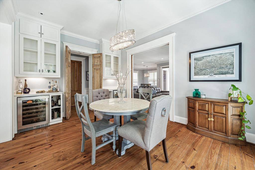 The dining room features dual custom cabinetry with glass-front uppers, a built-in wine and beverage refrigerators and open shelving for spirits and barware. It’s both beautiful and functional—perfect for hosting with ease.
