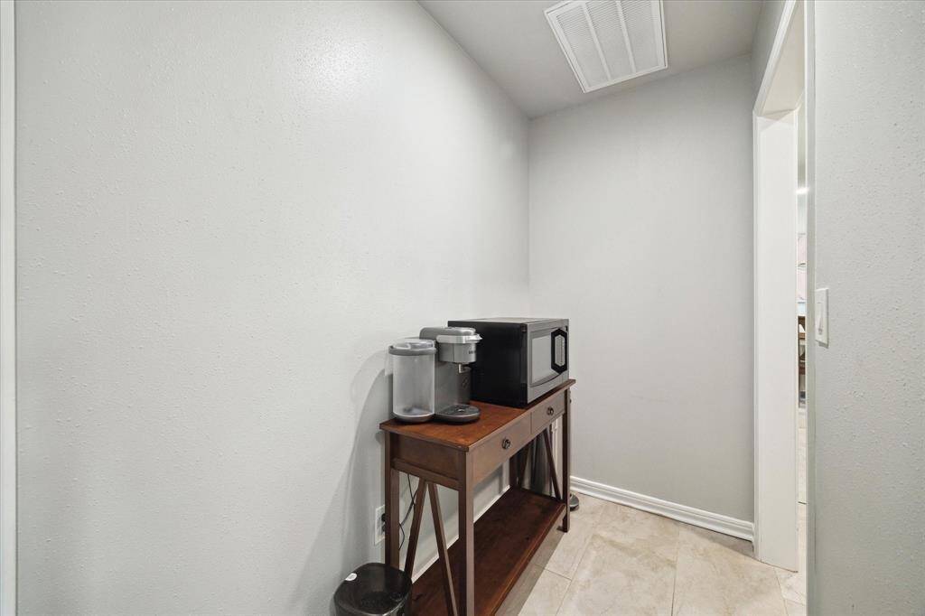 Extra space between kitchen and laundry room. So many possibilities for this space