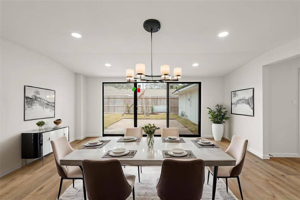 Large glass sliding doors seamlessly connect the indoor space to the backyard. **Room has been virtually staged.