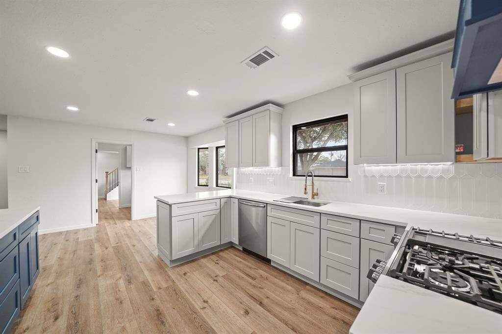 This beautifully remodeled kitchen blends modern elegance with functionality.