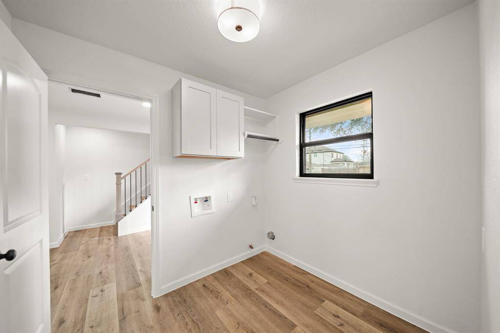 Primary suite offers dual sink with quartz counters and tons of cabinets for storage.
