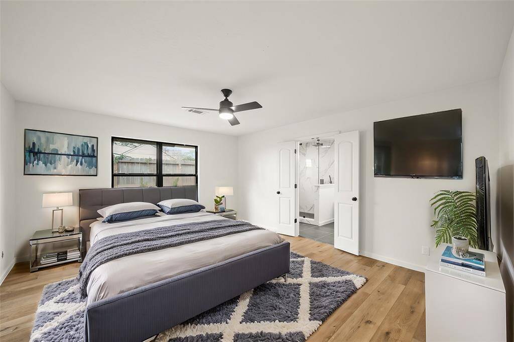 Primary bathroom offers a relaxing oversized glass enclosed shower with costume floor-to-ceiling tile design.
