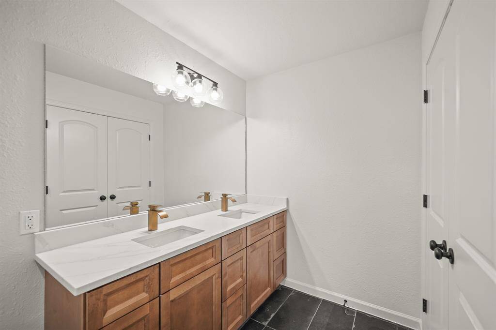 This walk-in closet is complete with open shelving, drawers and clothing rods.