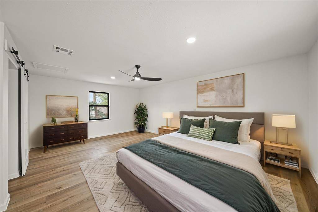 The upstairs bathroom features a sink and relaxing walk-in shower with custom tile design.
