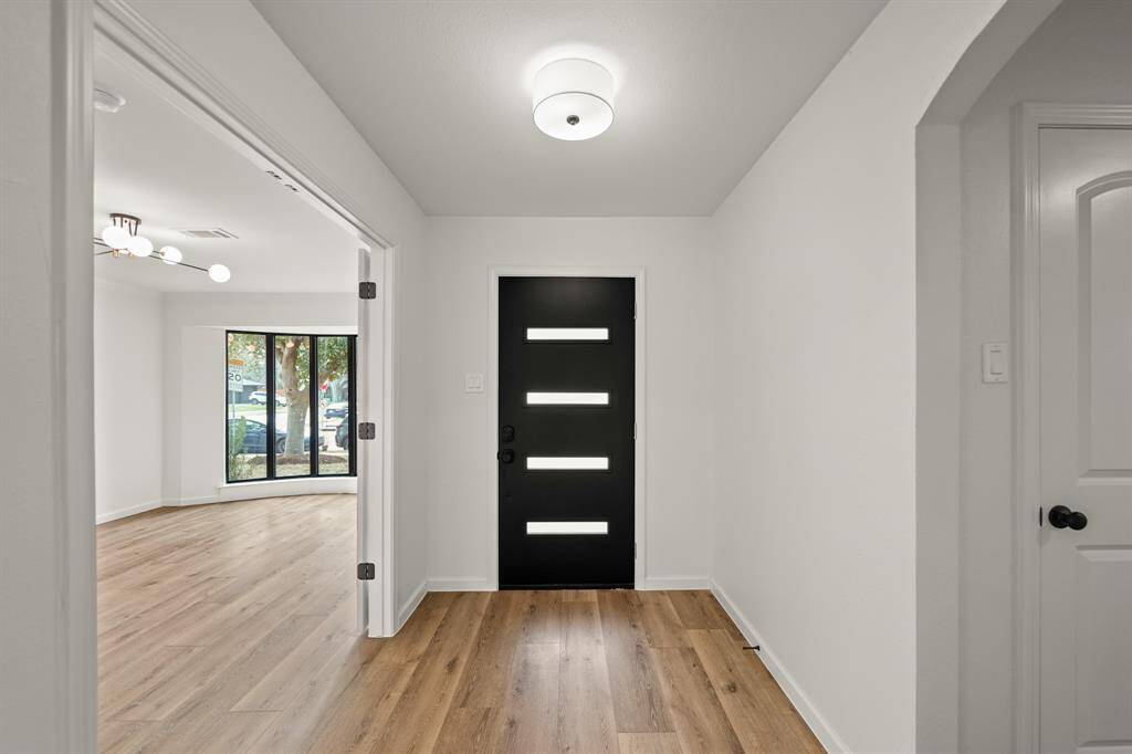This view of the foyers showcases the spacious living room and the private study on the right side.