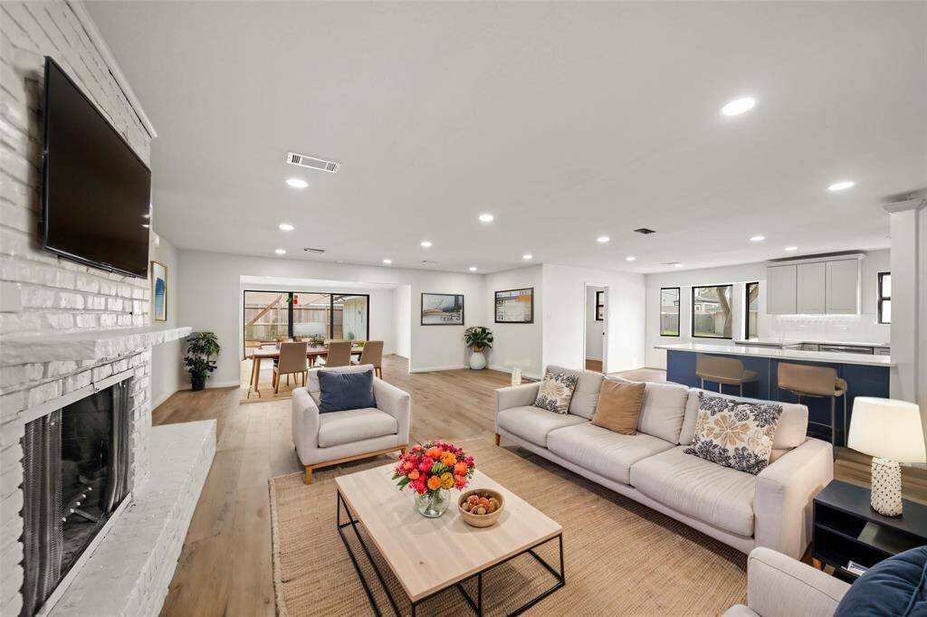 This stunning family room features an open-concept layout with a bright and airy ambiance. ^^This room has been virtually staged.