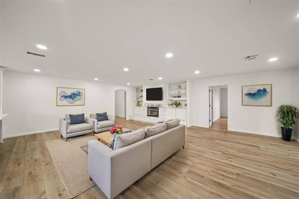 Warm-toned vinyl plank flooring extends throughout the first floor, complementing the neutral color palette. **Room has been virtually staged.