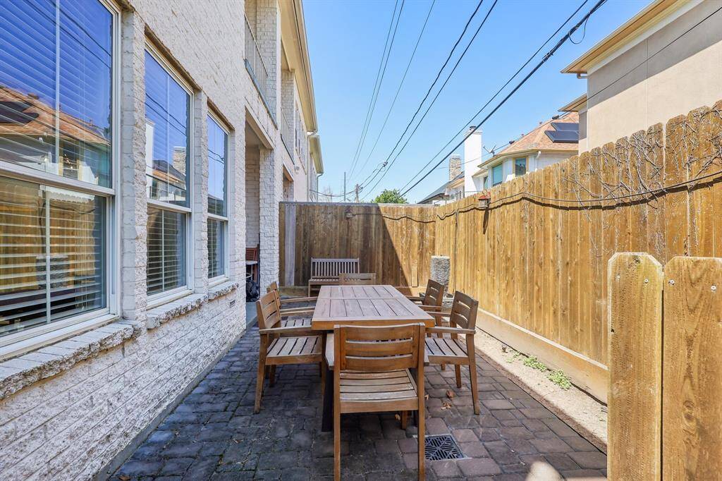 Cozy outdoor patio area with concrete pavers provides a private space for outdoor gatherings.