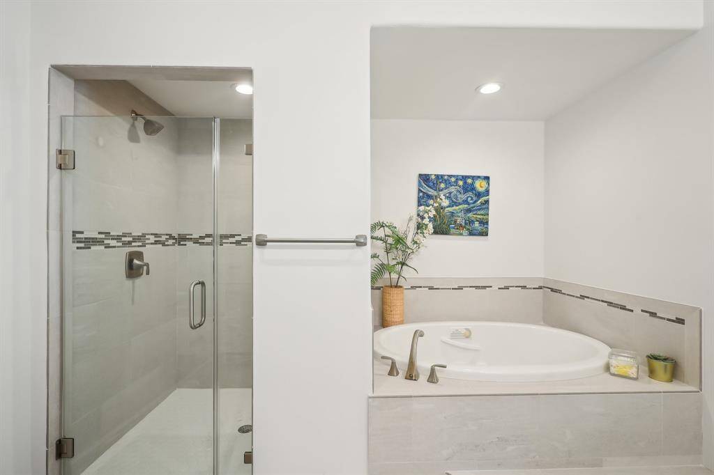 Primary suite oversized shower and garden tub.