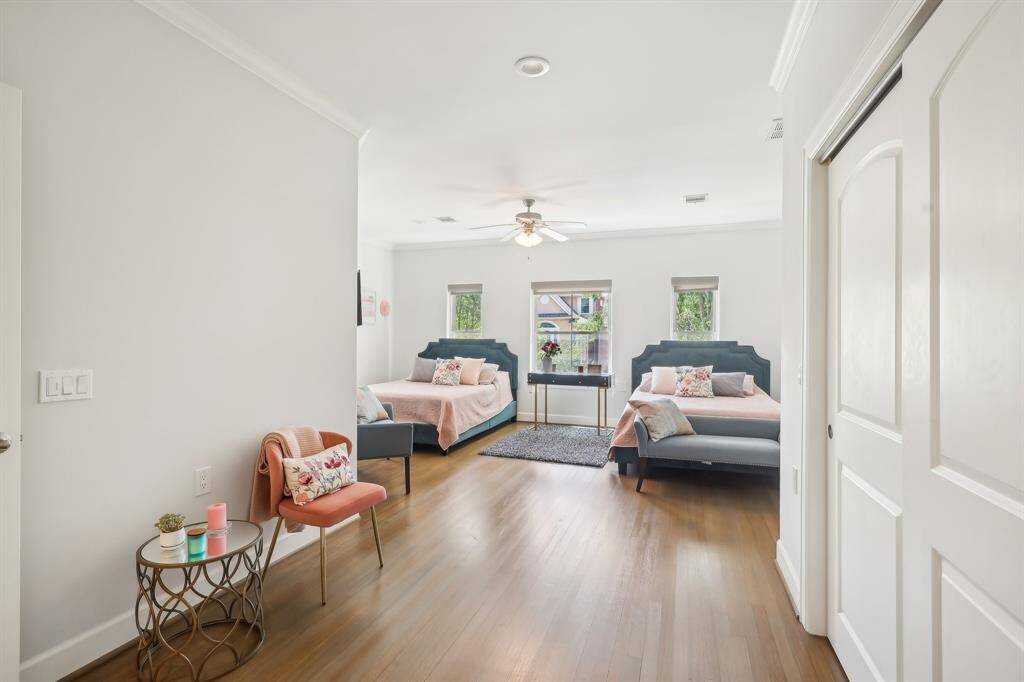 Another view of spacious second floor bedroom. The light hardwood floors and neutral walls create a bright and inviting atmosphere.