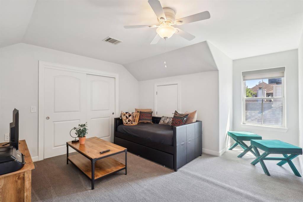 This  third floor open room has a ceiling fan, a window providing natural light, and a closet with double doors and This spacious room is ideal for a game room or hobby room.