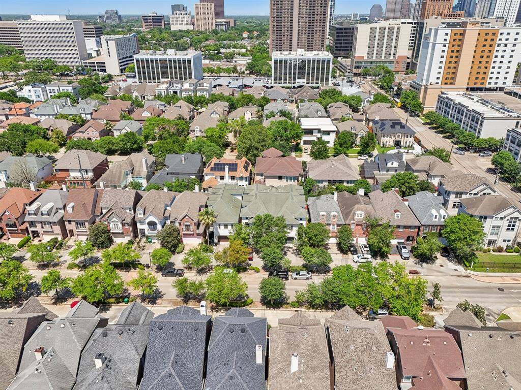St. George Place is a neighborhood with charming, diverse homes lined along tree-lined streets. The area is urban, with high-rise buildings in the distance, suggesting a convenient proximity to city amenities.