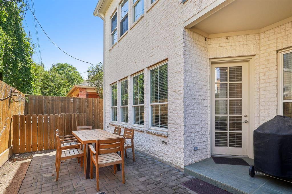 Backyard patio is enclosed by a wooden fence for privacy.