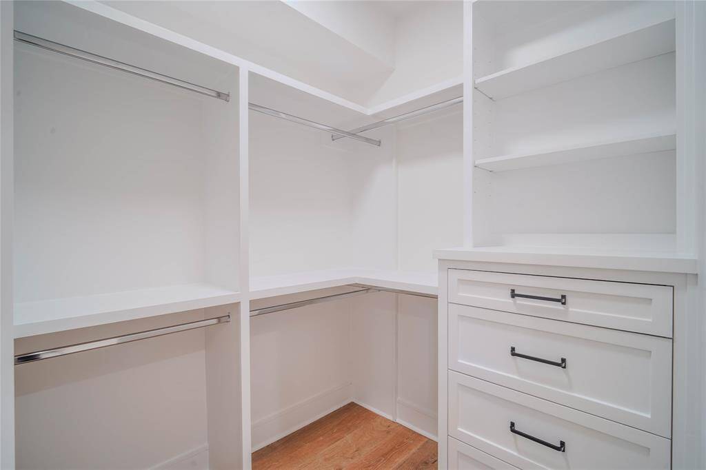 The Primary Bedroom closet features built-in shelves and drawers.