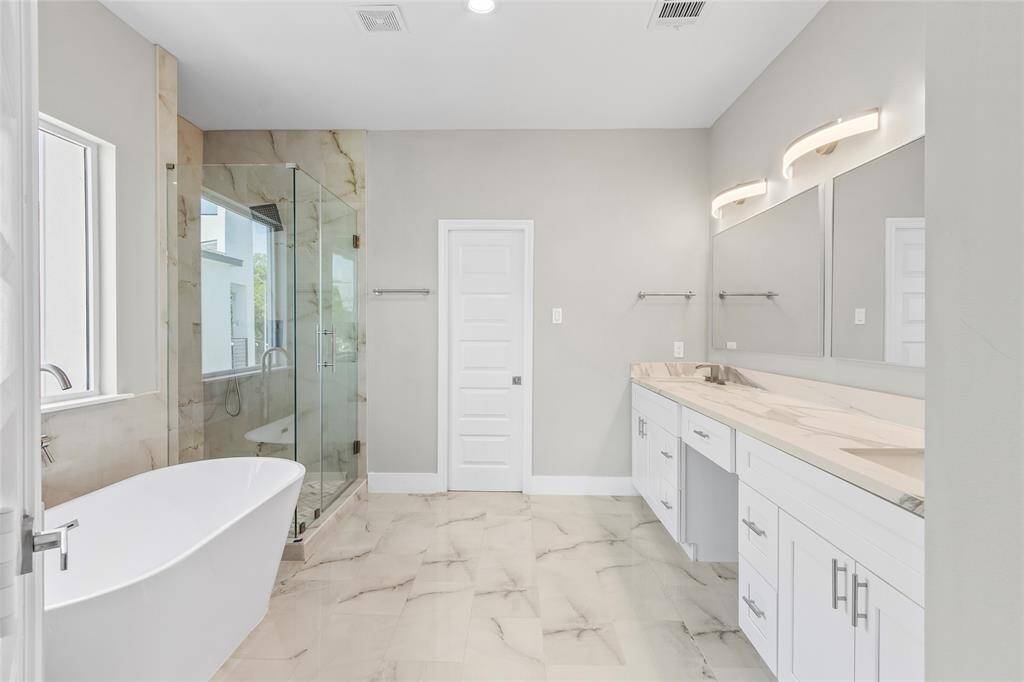 Primary bedroom huge and spacious bathroom with spa tub and frameless shower