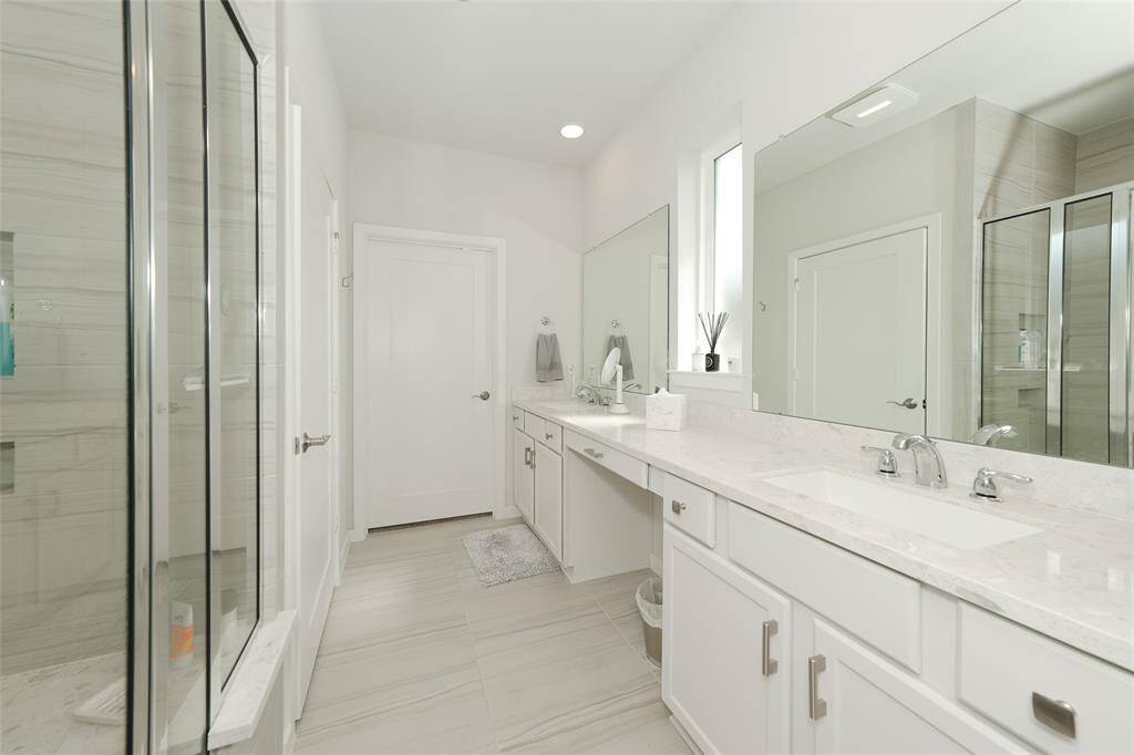 Primary bathroom with stand up shower and bench