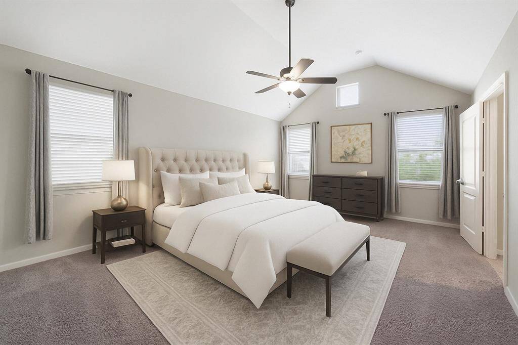 Virtually staged: Indulge in the ultimate retreat within this exquisite home. The primary suite boasts a stunning vaulted ceiling, expansive windows that flood the space with natural light, and a spa-like ensuite bathroom. A generously sized walk-in closet completes this luxurious sanctuary.