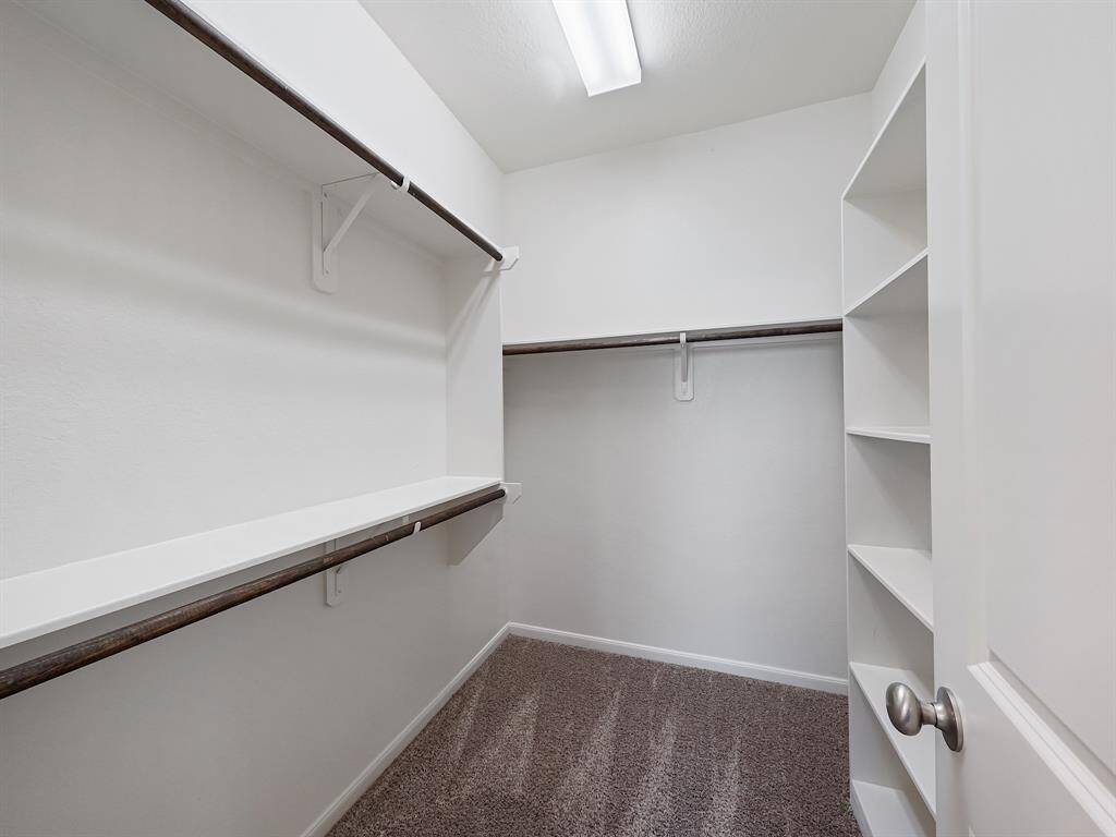 The generously sized walk-in closet provides ample storage space and organization options.