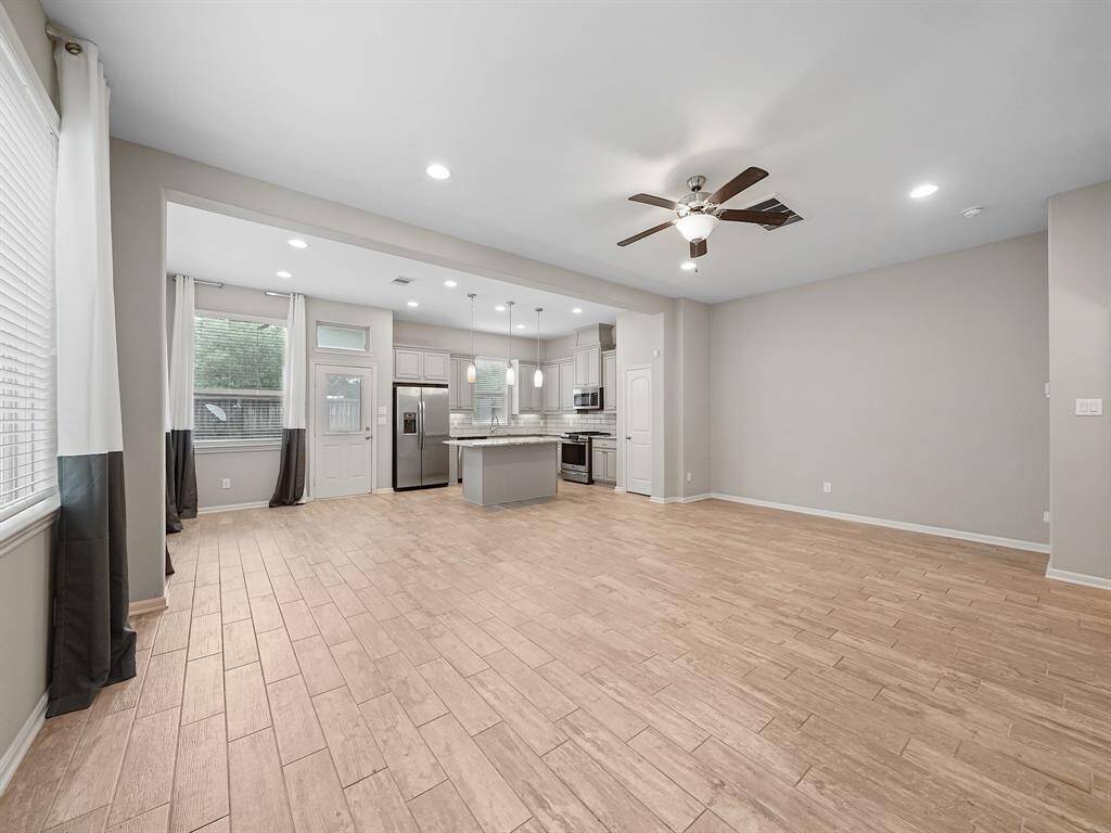 As you step inside, you are immediately greeted by an inviting open-concept layout. Wood-look tile flooring on main floor. The expansive living room effortlessly flows into the gourmet kitchen and adjacent dining area, creating a seamless space ideal for both intimate gatherings and larger-scale entertaining.