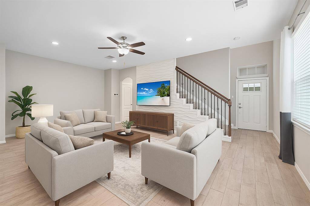 Virtually staged: Unwind in the expansive living area, where a striking accent wall creates a captivating focal point.