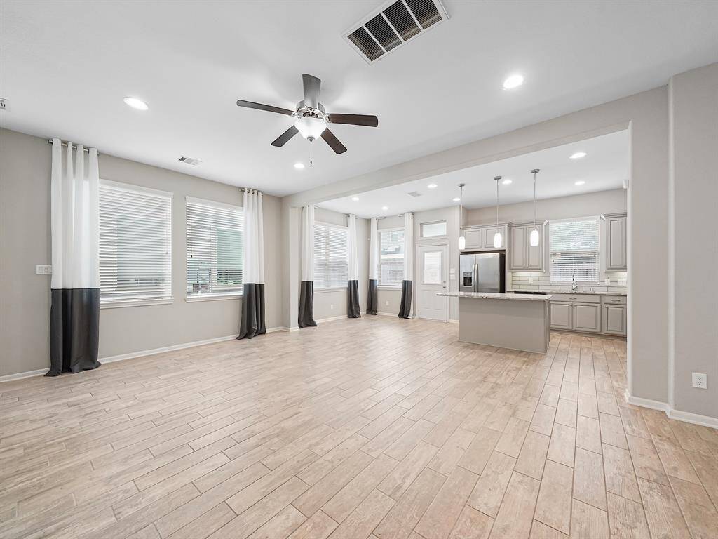 Enjoy a bright and inviting great room with expansive windows and high ceilings that maximize natural light.