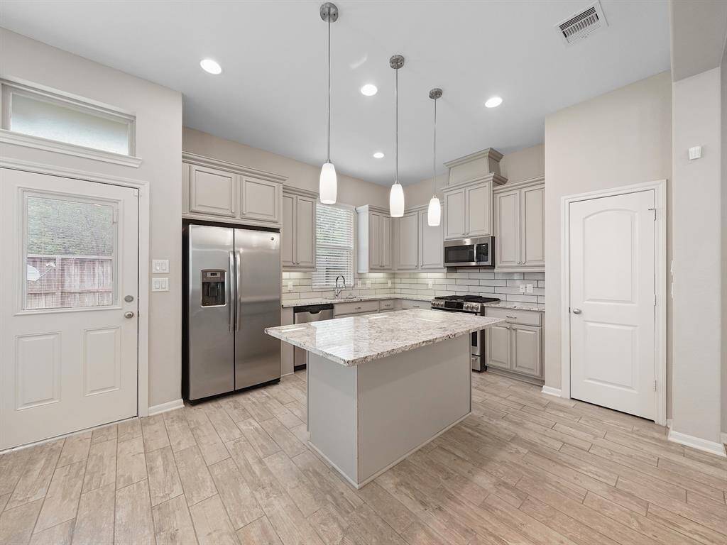 This property boasts an island that provides additional storage and ample preparation space in the kitchen. A large pantry further enhances the home's storage capabilities.