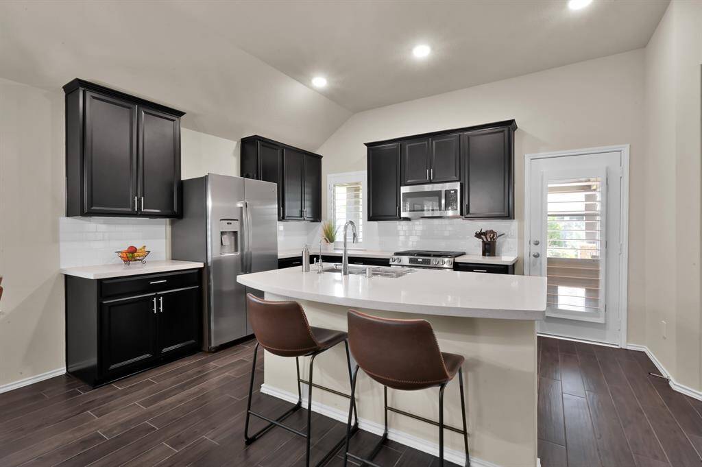 This kitchen features upgraded appliances, spacious countertops, and under cabinet lighting.