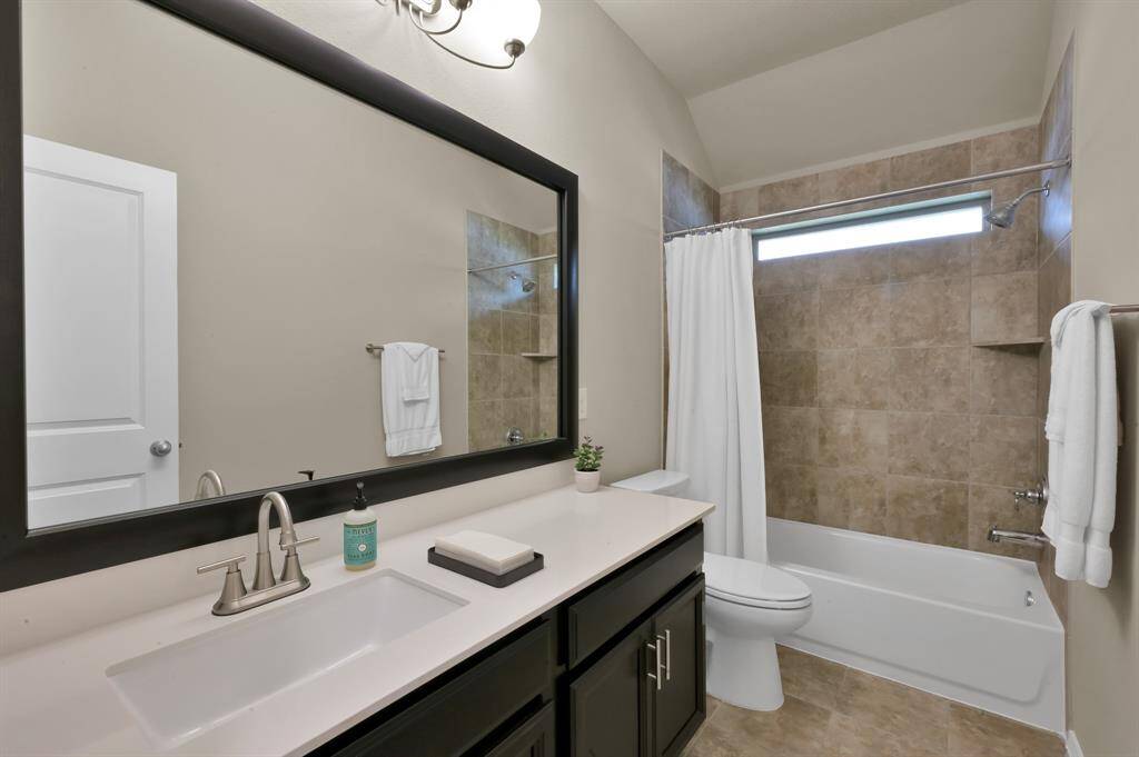 Secondary bathroom conveniently located between secondary bedroom #1 and secondary bedroom #2 towards the front of the home.