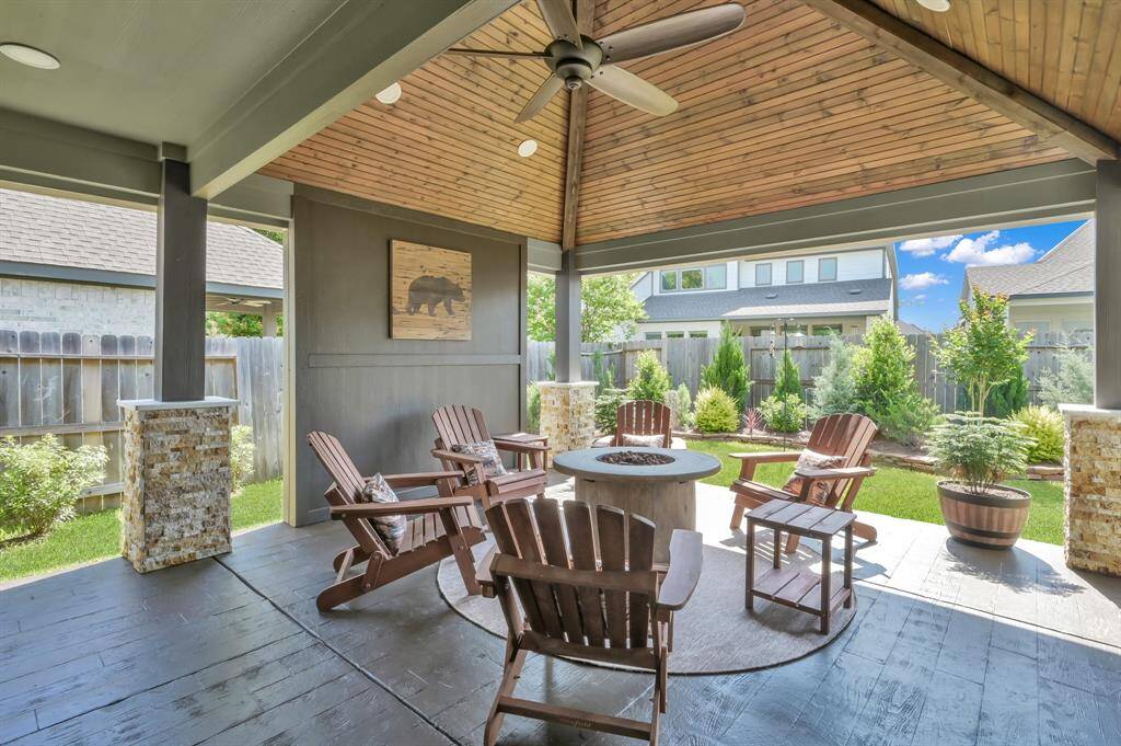 Welcome to your BACKYARD PARADISE featuring a CUSTOM covered patio, wood-like stamped concrete, and upgraded landscaping/hardscape.