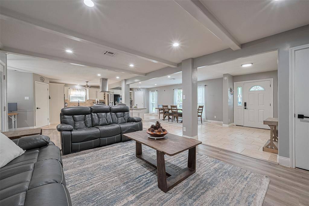 Spacious & open living area with modern finishes featuring a comfortable seating area, dining space, and a well-equipped kitchen. Natural light fills the space, and the neutral color palette enhances the inviting atmosphere. The layout is ideal for entertaining & family living.