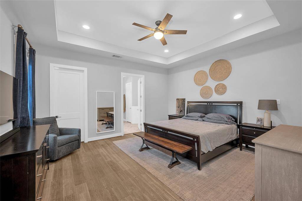 The spacious first floor primary suite with large walk in closet and luxurious bath.