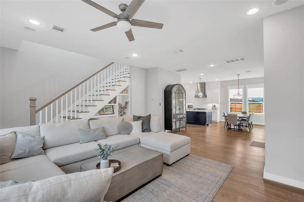 Spacious open concept floorplan flooded with natural lighting. Neutral paint throughout + windows dressed with shades.