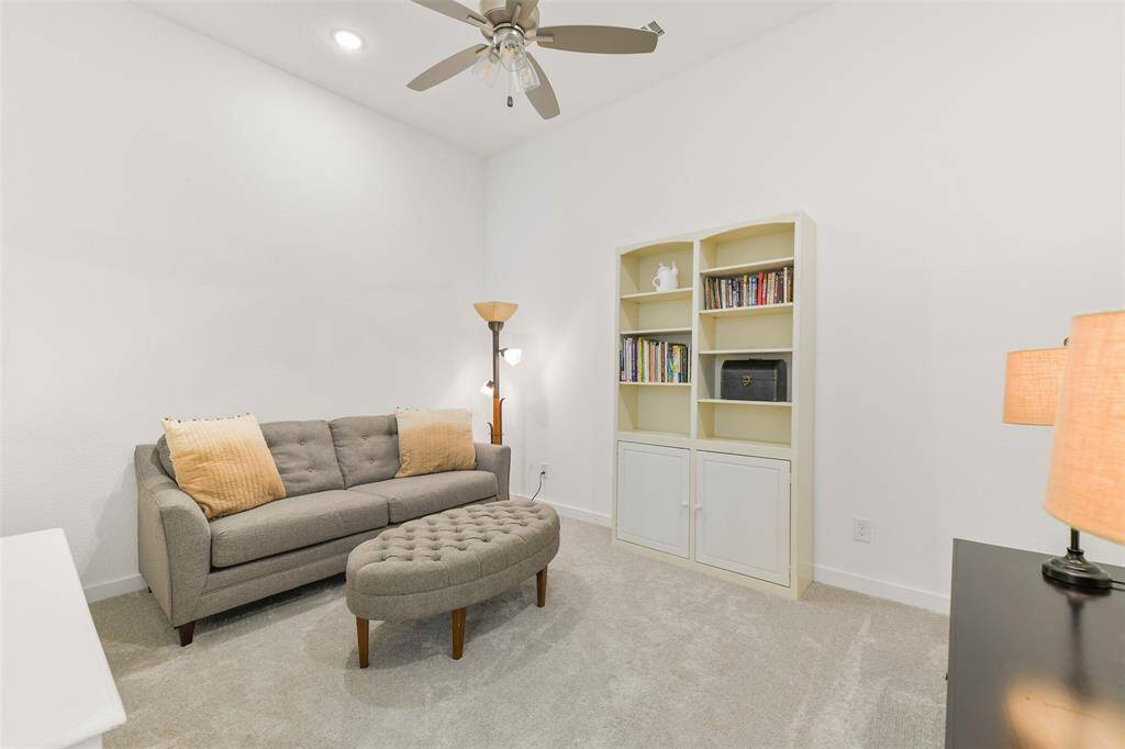 This flex-use space is tucked off of the kitchen, between the built-in buffet and the family room. It's perfectly suited for use as a game room, a media room, or an exercise room and it offers high ceilings, plush carpet, a lighted fan, and double doors.