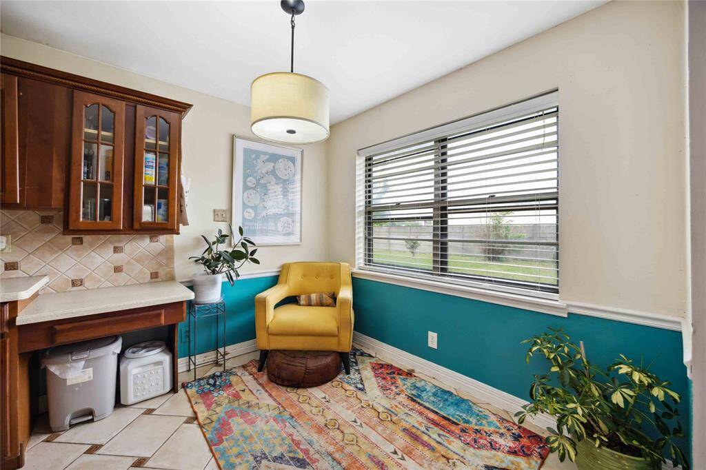 The breakfast area rests to the side of the kitchen counter which currently includes a built-in desk area.