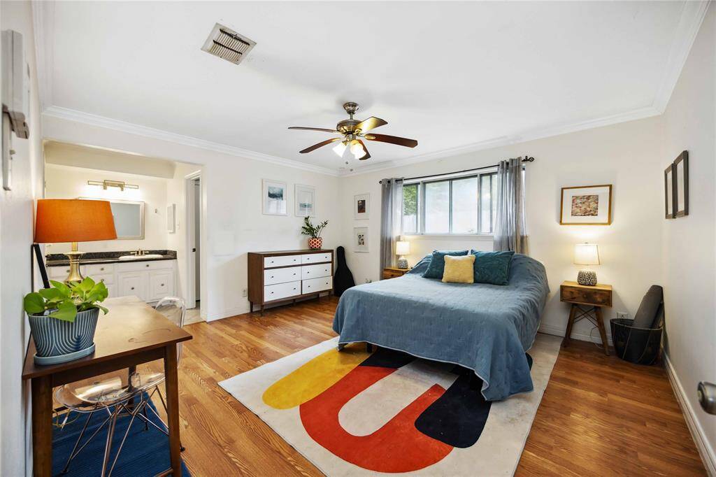 The primary bedroom features Crown molding and currently offers an open vanity.