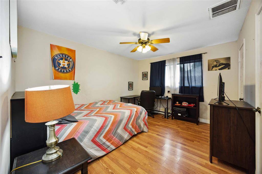 A spacious second bedroom offers space for seating and a desk.