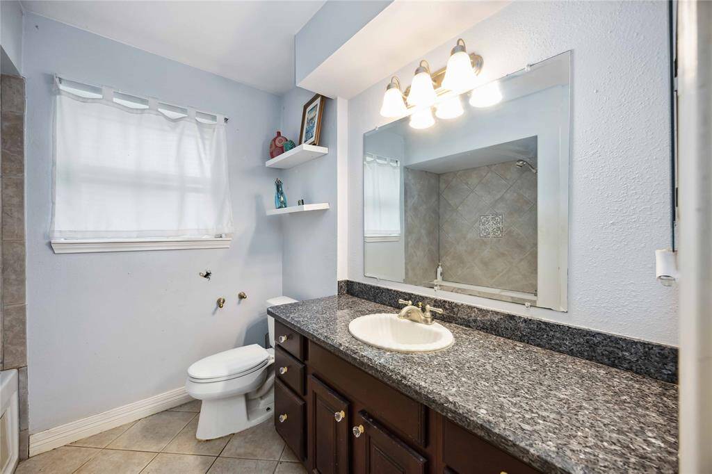 The second bath is located conveniently accessible to both secondary bedrooms.