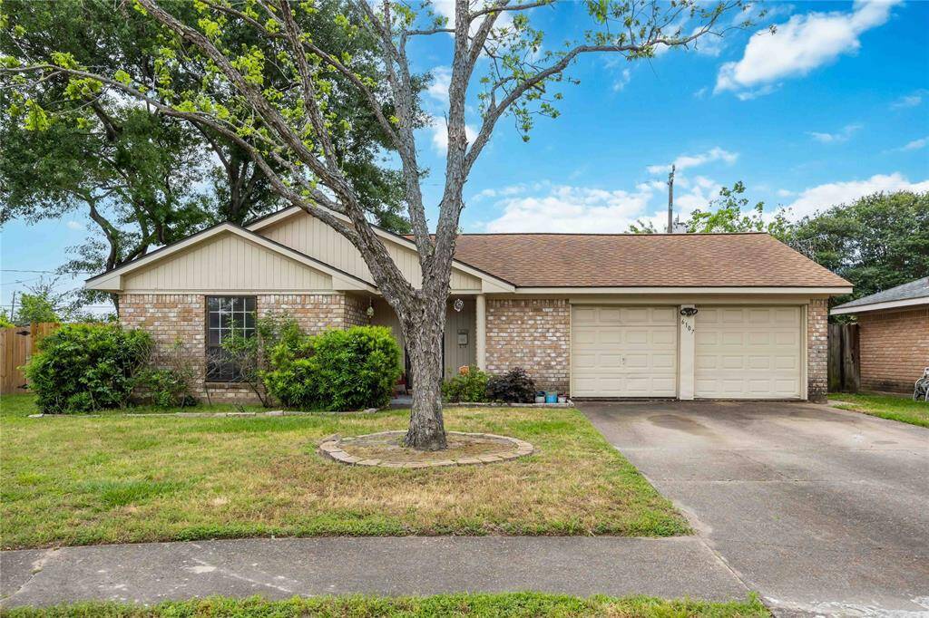 The home offers 3 bedrooms, 2 baths, a 2-car garage, and trees in front and back!
