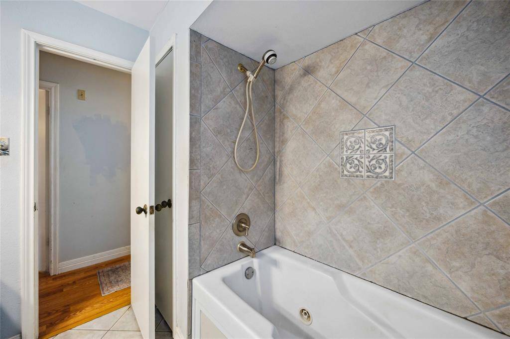 The second bath includes a tub and shower combination with a tile surround.