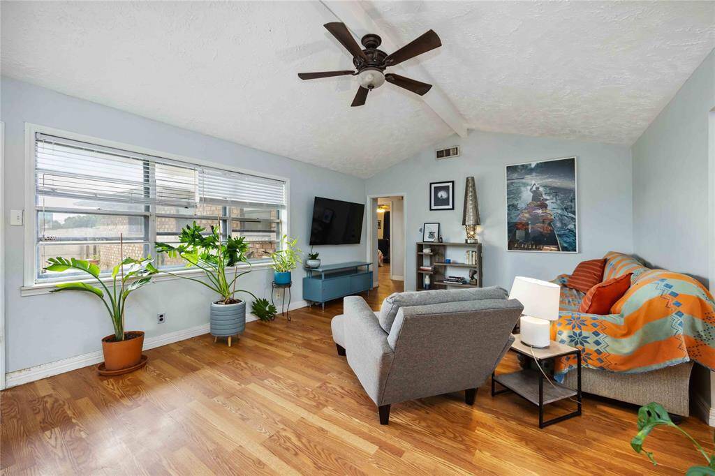 From the living room, notice the hallway that leads toward the bedrooms and baths.
