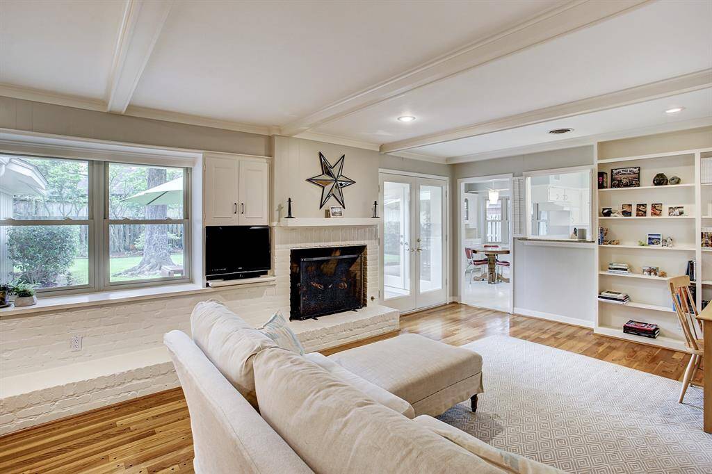 Family room opens to Kitchen. Wall of built-ins, custom ceiling with recessed lighting.