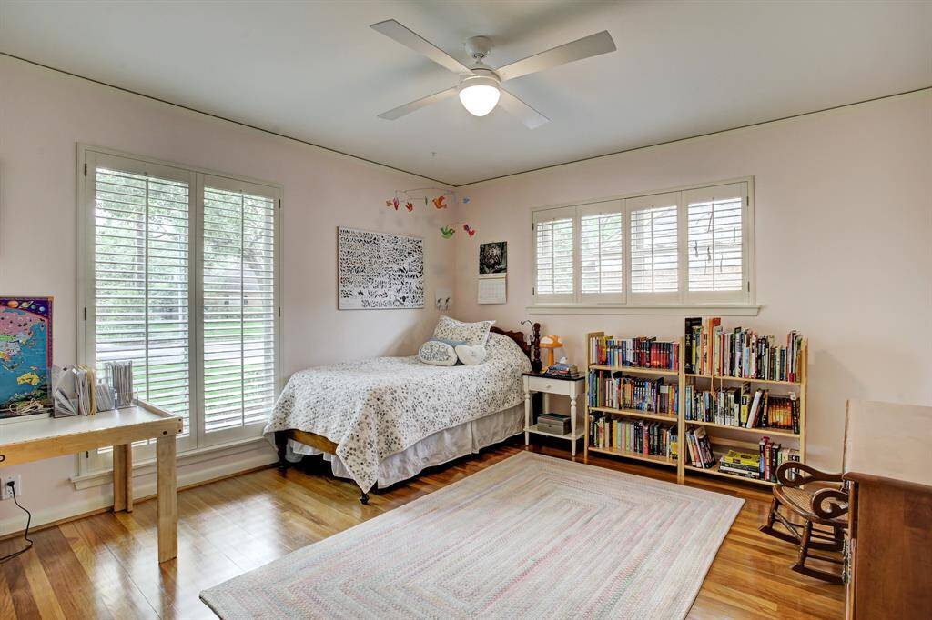 Wonderful front bedroom has impressive windows, plantation shutters & ceiling fan.