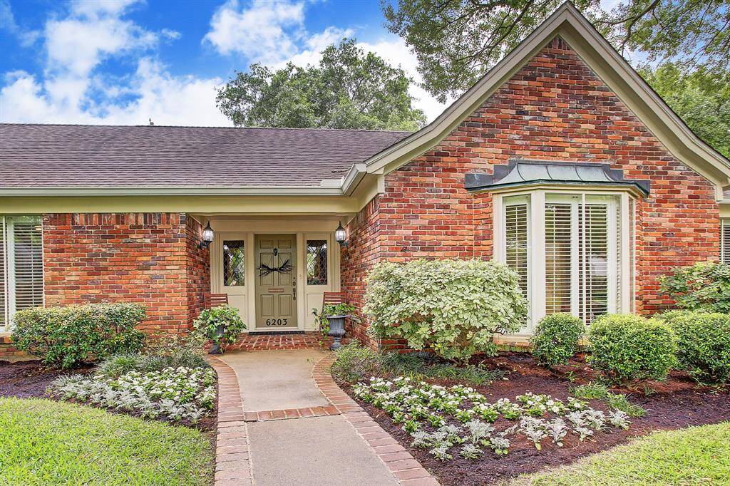 Picture perfect home with gorgeous landscaped yard, tall trees, sprinkler system. Inviting covered front porch and bay window.