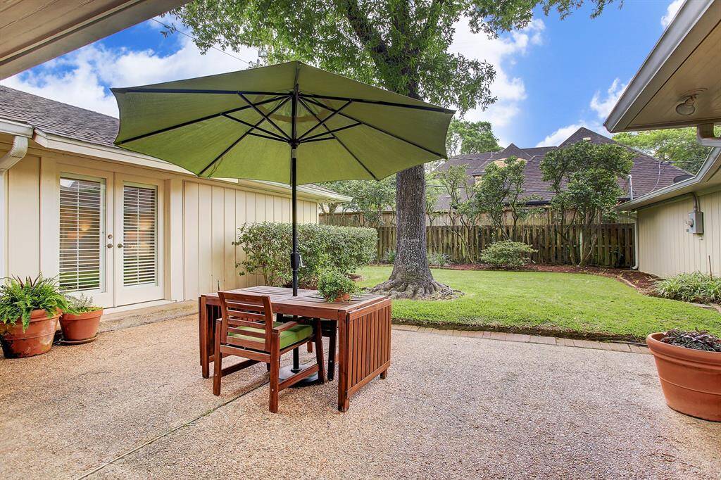 Inviting covered patio and expansive fenced back yard. Tall Oak trees for shade in front & back yard.