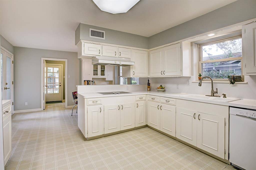 Expansive kitchen with large window and great outside views. Handsome fixtures and Abundant cabinets.