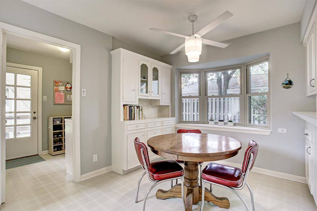 Delightful Breakfast Room with ceiling fan, built-ins & charming window seat.