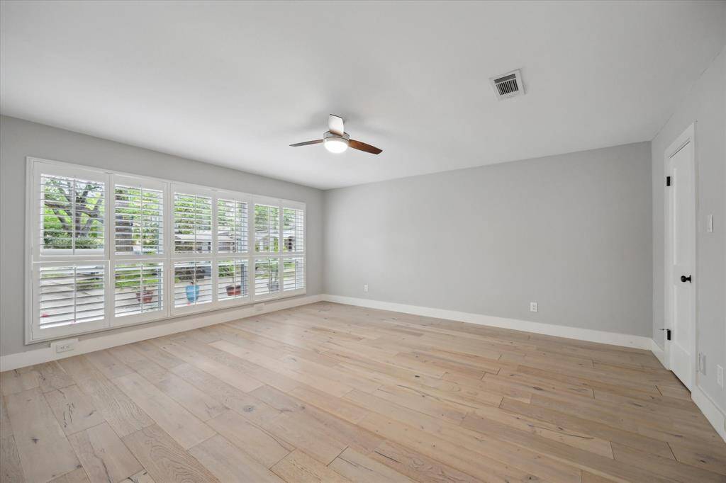 The front secondary bedroom offers privacy and versatility, thoughtfully positioned apart from the other bedrooms—an ideal setup for guests or a mother-in-law suite. It features classic shutters and an en-suite bathroom with dual access, adding both convenience and flexibility to the space.