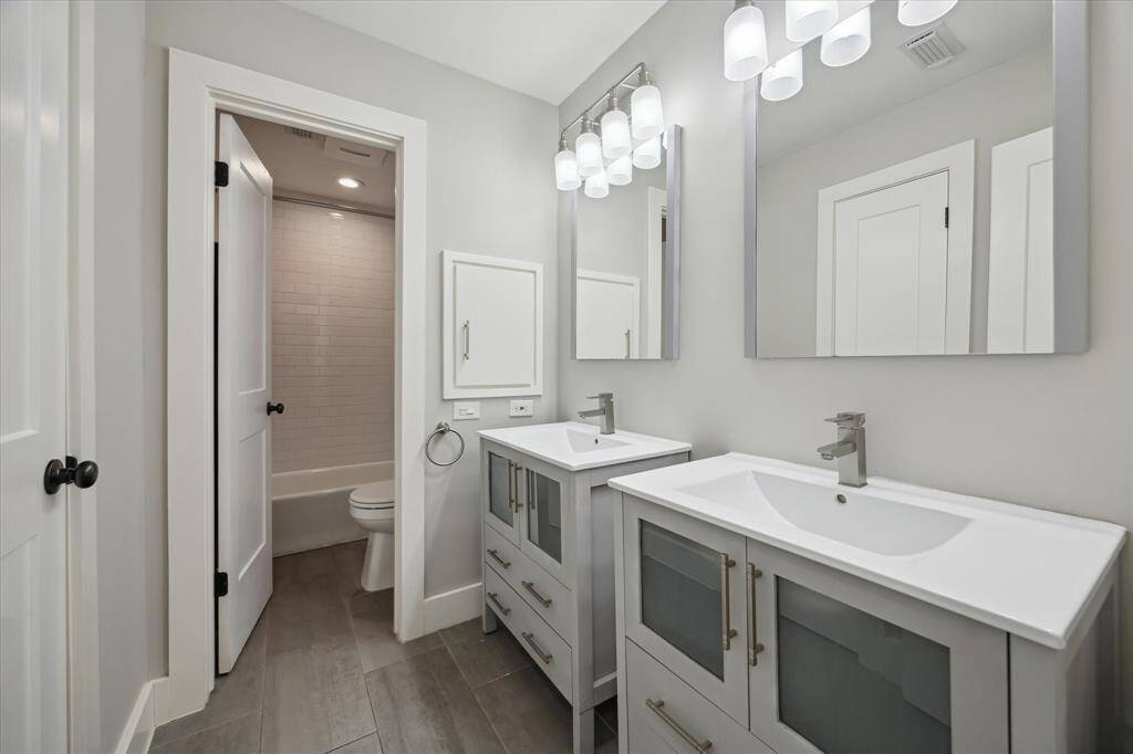 The secondary Hollywood bathroom is accessible from the hallway, providing a functional layout that allows multiple people to get ready with ease—without disrupting one another’s morning routine.
